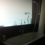 BATHTUB WITH OPAQUE GLASS TOWARD KITCHEN